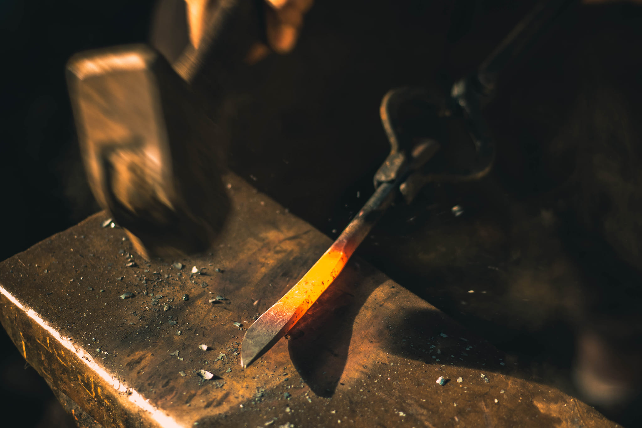 flattening the blade with a forging hammer